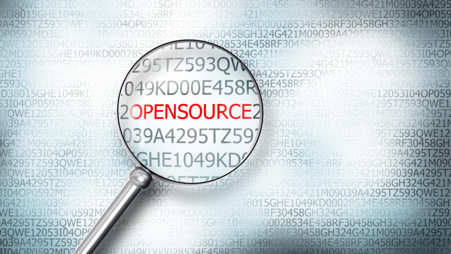 reading the word opensource on computer screen with a magnifying glass
